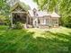Charming white brick home with a screened-in porch and stone fire pit at 4715 Lenden Hall Ct, Gastonia, NC 28056