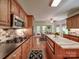 Spacious kitchen featuring stainless steel appliances, brick backsplash, and an island with a marble countertop at 4715 Lenden Hall Ct, Gastonia, NC 28056
