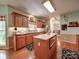 Bright kitchen with wooden cabinets, stainless steel appliances, center island, and a view into the dining area at 4715 Lenden Hall Ct, Gastonia, NC 28056