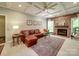 Comfortable living room with a brick fireplace, coffered ceiling, and plenty of natural light at 4715 Lenden Hall Ct, Gastonia, NC 28056