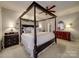 Elegant main bedroom featuring a canopy bed, dark wood accents, and a comfortable atmosphere at 4715 Lenden Hall Ct, Gastonia, NC 28056