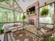 Relaxing sunroom with brick fireplace, vaulted ceiling, and screened windows overlooking the backyard at 4715 Lenden Hall Ct, Gastonia, NC 28056