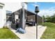 Large backyard area featuring an outdoor kitchen and a pergola with outdoor seating, perfect for relaxing at 5121 Ennisworth Ln, Charlotte, NC 28214