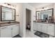Bright bathroom featuring double vanity, white cabinets and modern fixtures with toilet in separate room at 5121 Ennisworth Ln, Charlotte, NC 28214