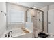 This bathroom features a luxurious soaking tub and a glass-enclosed shower with marble tile at 5121 Ennisworth Ln, Charlotte, NC 28214