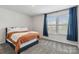 Cozy bedroom with plush carpeting, natural light, and blue curtains at 5121 Ennisworth Ln, Charlotte, NC 28214