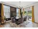 Dining area featuring modern chandelier, dark accent wall, and large sliding glass door at 5121 Ennisworth Ln, Charlotte, NC 28214