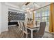 Bright dining room featuring modern light fixture, stylish decor and hardwood floors at 5121 Ennisworth Ln, Charlotte, NC 28214