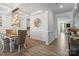 Elegant dining room featuring modern chandelier, decorative mirror, and coffered ceiling at 5121 Ennisworth Ln, Charlotte, NC 28214