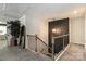 Upstairs hallway with wood railing and black spindles, complemented by a modern light fixture and accent wall at 5121 Ennisworth Ln, Charlotte, NC 28214