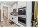 Well-equipped kitchen with stainless steel microwave and oven, gas cooktop, and ample white cabinetry at 5121 Ennisworth Ln, Charlotte, NC 28214