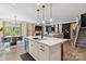 Open kitchen showcasing island with seating, stainless steel appliances, and adjacent dining area at 5121 Ennisworth Ln, Charlotte, NC 28214
