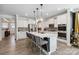 Spacious kitchen with a large island, seating, stainless steel appliances, and ample storage at 5121 Ennisworth Ln, Charlotte, NC 28214
