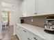 Kitchen area featuring white cabinets, quartz countertops, and stainless steel appliances at 5121 Ennisworth Ln, Charlotte, NC 28214