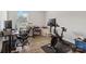 Well-lit home office with a desk, rolling chair, and exercise bike at 5121 Ennisworth Ln, Charlotte, NC 28214