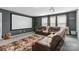 Home theater with a sectional sofa, a projector screen, and plush carpet for a cinematic experience at 5121 Ennisworth Ln, Charlotte, NC 28214