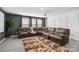 Cozy theater room featuring a large leather sectional sofa, projector screen, and plush carpet at 5121 Ennisworth Ln, Charlotte, NC 28214