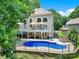 Stunning backyard view featuring a private pool, a white balcony, a charming patio, and mature trees, a perfect retreat at 524 Wildbrook Walk, Fort Mill, SC 29708