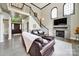 Inviting living room with fireplace, staircase, and soaring ceilings with ample natural light at 524 Wildbrook Walk, Fort Mill, SC 29708