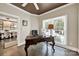 Home office featuring a ceiling fan, a large desk, a window, hardwood floors, and view into dining room at 524 Wildbrook Walk, Fort Mill, SC 29708