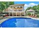A refreshing swimming pool is the focal point, complemented by a spacious patio and an elegant two-story home at 524 Wildbrook Walk, Fort Mill, SC 29708
