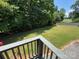 View of a large, grassy backyard with bordering trees and a fence for privacy at 533 Tuckers Grove Rd, Statesville, NC 28625
