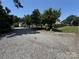 Gravel driveway leading up to a house, bordered by greenery and a black chain link fence at 533 Tuckers Grove Rd, Statesville, NC 28625