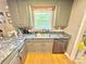 This kitchen showcases stainless steel appliances, gray cabinets and a window over the sink at 533 Tuckers Grove Rd, Statesville, NC 28625
