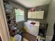 Functional laundry area with a washer, dryer, and overhead storage at 533 Tuckers Grove Rd, Statesville, NC 28625