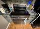 Stainless steel range with a smooth cooktop and gray cabinets at 533 Tuckers Grove Rd, Statesville, NC 28625