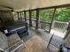 Relaxing screened porch with a hot tub overlooking a wooded lot at 533 Tuckers Grove Rd, Statesville, NC 28625