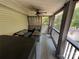 Relaxing screened porch with seating, curtains, and a ceiling fan overlooking a wooded lot at 533 Tuckers Grove Rd, Statesville, NC 28625