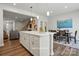 Contemporary kitchen flows to the dining area, complete with a quartz island and seating at 7148 Hodges Meadow Ln, Charlotte, NC 28213