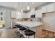 Stylish kitchen boasts a spacious island with seating and contemporary lighting fixtures at 7148 Hodges Meadow Ln, Charlotte, NC 28213