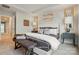 Inviting main bedroom with a bench, neutral colors, and lots of natural light at 7148 Hodges Meadow Ln, Charlotte, NC 28213