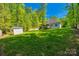 A well-manicured lawn and shed complement the home's exterior, creating a serene outdoor space at 7435 Hammond Dr, Charlotte, NC 28215