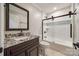 Bathroom vanity with dark wood cabinetry, granite countertop, and updated fixtures at 7435 Hammond Dr, Charlotte, NC 28215