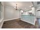 Bright breakfast nook with hardwood floors, a chandelier, and access to a modern kitchen at 7435 Hammond Dr, Charlotte, NC 28215