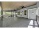 This view shows a gray wood deck overlooking the back yard, with a tongue and groove ceiling and two ceiling fans at 7435 Hammond Dr, Charlotte, NC 28215