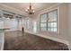 Bright dining area with hardwood floors, coffered ceilings, and a modern chandelier at 7435 Hammond Dr, Charlotte, NC 28215