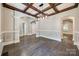 Elegant dining room featuring hardwood floors, coffered ceiling, and access to a kitchen at 7435 Hammond Dr, Charlotte, NC 28215