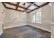 Bright dining room featuring hardwood floors, a large window, and coffered ceiling at 7435 Hammond Dr, Charlotte, NC 28215