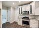 Bright kitchen showcasing white cabinets, stainless steel appliances, and granite countertops at 7435 Hammond Dr, Charlotte, NC 28215