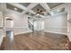 Spacious living room featuring hardwood floors, coffered ceiling, and plenty of natural light at 7435 Hammond Dr, Charlotte, NC 28215