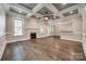 Inviting living room featuring hardwood floors, a fireplace, and a coffered ceiling at 7435 Hammond Dr, Charlotte, NC 28215