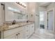 Main bathroom showcasing double vanities, granite countertops, and tiled shower at 7435 Hammond Dr, Charlotte, NC 28215