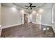 Main bedroom with hardwood floors, coffered ceiling, and access to main bathroom at 7435 Hammond Dr, Charlotte, NC 28215