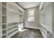 Bright walk-in closet with custom shelving and a window for natural light at 7435 Hammond Dr, Charlotte, NC 28215