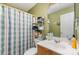 Cozy bathroom featuring a vanity, mirror, and shower curtain for added privacy at 7504 Petrea Ln, Charlotte, NC 28227