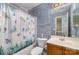 Blue-themed bathroom with shower and vanity at 7504 Petrea Ln, Charlotte, NC 28227